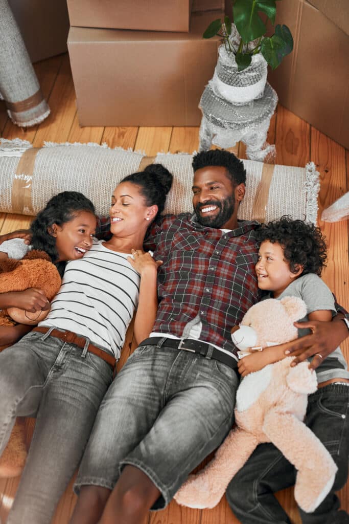 everyone seems be loving new house shot family four lying together floor their new home
